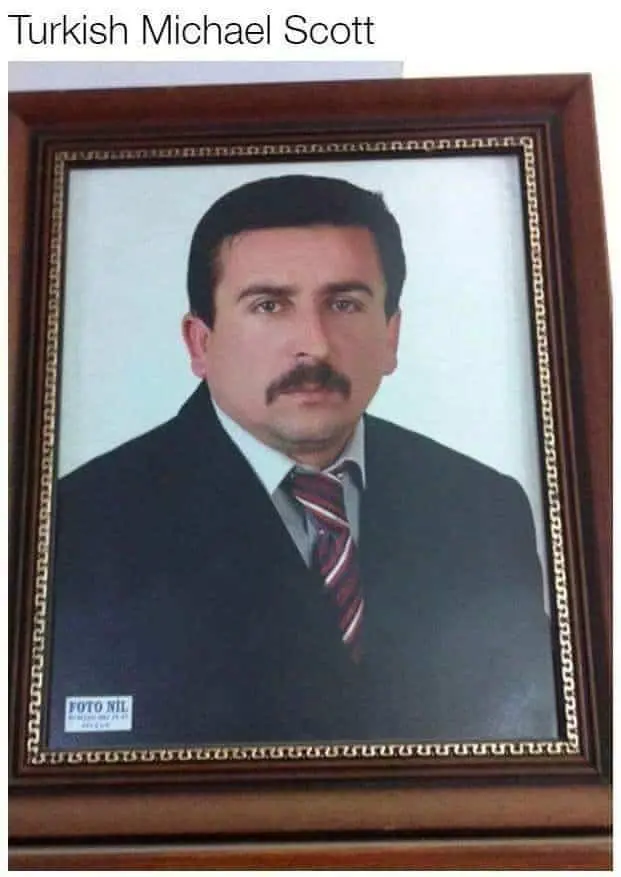 Framed portrait of a man with a mustache in a suit, labeled as "Turkish Michael Scott."