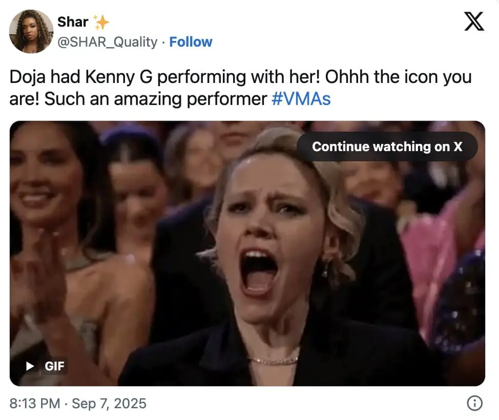 Audience member with mouth wide open cheering and clapping in delight