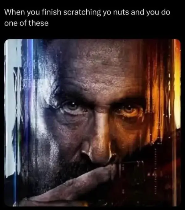 high-contrast hilarious meme featuring a cinematic shot of a bearded man bringing his finger to his nose in deep thought. The caption describes a gross but universal habit: "When you finish scratching yo nuts and you do one of these."