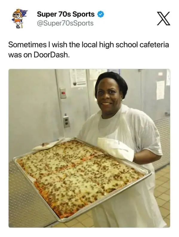 Food delivery meme showing a post wishing the local high school cafeteria was on DoorDash, paired with a cafeteria worker proudly holding a huge tray of cheesy rectangular pizza, invoking cafeteria nostalgia, industrial mozzarella, and childhood’s most elite square meal.