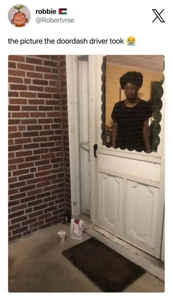Food delivery meme showing a social media post about “the picture the DoorDash driver took,” with a delivery confirmation photo where the customer is visibly standing behind the door window staring out, making the drop-off proof look like found footage from a haunted porch.