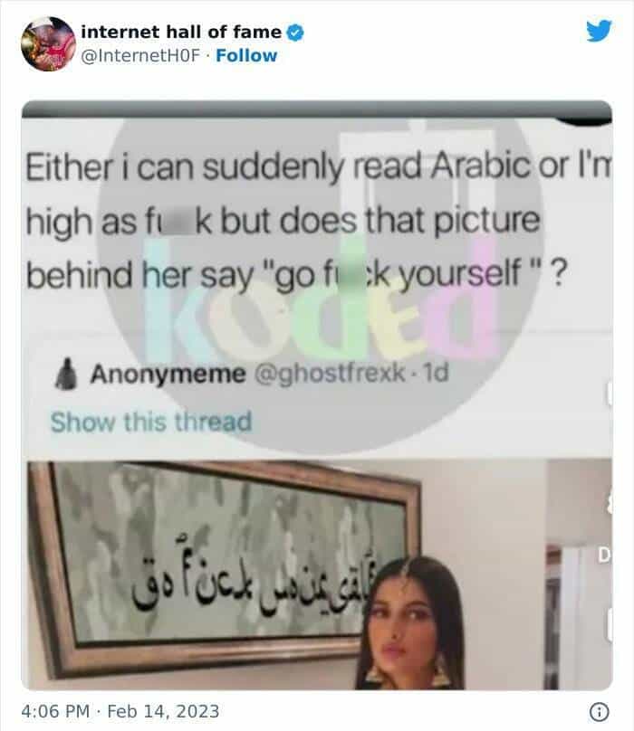 Either i can suddenly read Arabic or I' high as fi k but does that picture behind her say "go fi k yourself"?