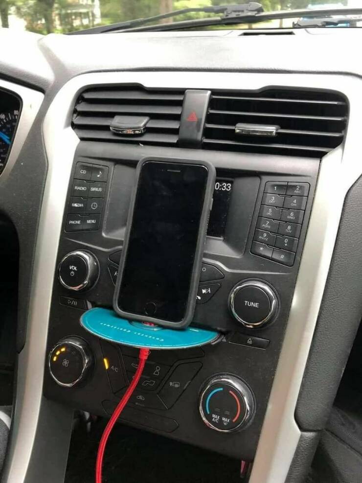 funny pics cd player in car used as Iphone holder