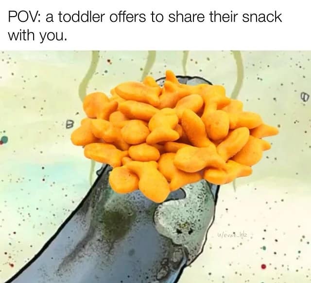 POV: a toddler offers to share their snack with you.