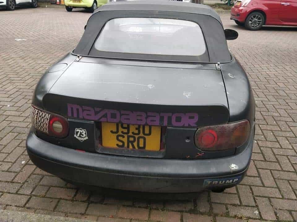 funny miata, miatas with threatening auras, comedic roadster bits, small convertible jokes, quirky sports car humor, Miata memes, comedic two-seater illusions, beloved tiny ride references, Mazda jokes, brand-based comedic angles, automaker witty bits, car humor, vehicular comedic lines, automotive meltdown commentary