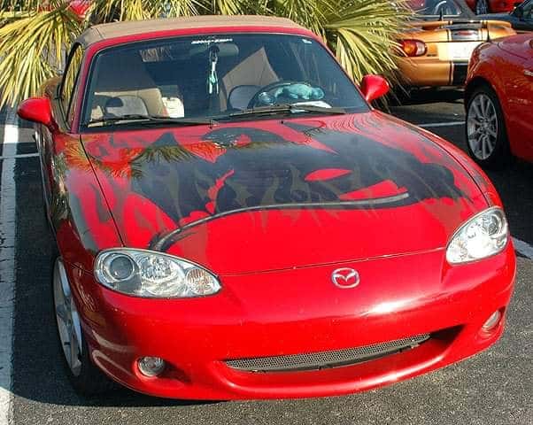 funny miata, miatas with threatening auras, comedic roadster bits, small convertible jokes, quirky sports car humor, Miata memes, comedic two-seater illusions, beloved tiny ride references, Mazda jokes, brand-based comedic angles, automaker witty bits, car humor, vehicular comedic lines, automotive meltdown commentary