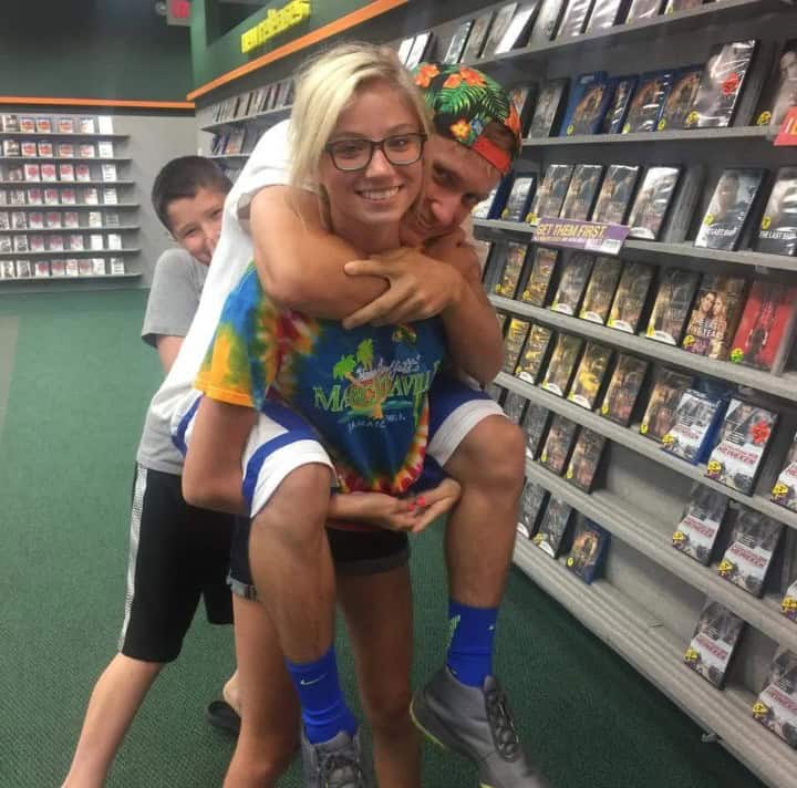 funny optical illusions photo of three people in a store, with the middle person appearing to have four legs due to the people behind