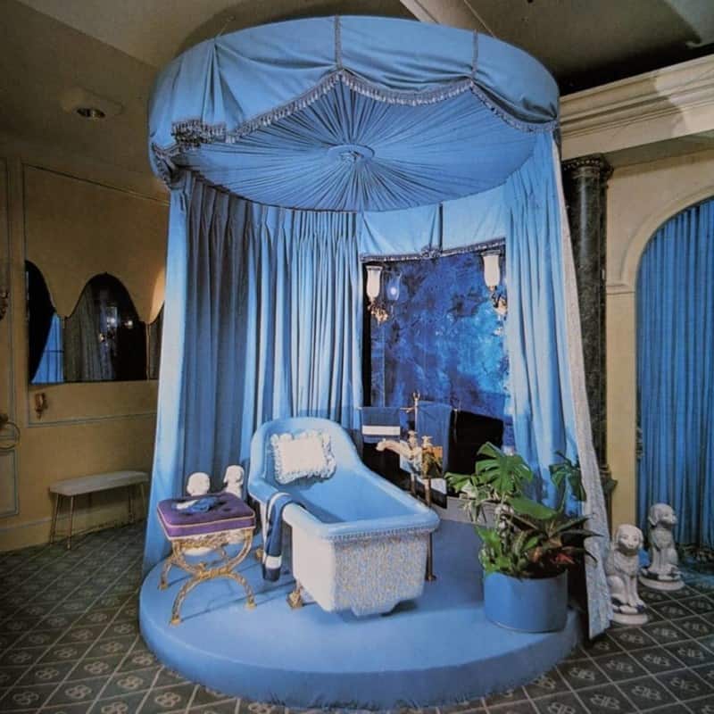 Blue retro bathroom with canopy tub and theatrical drapes