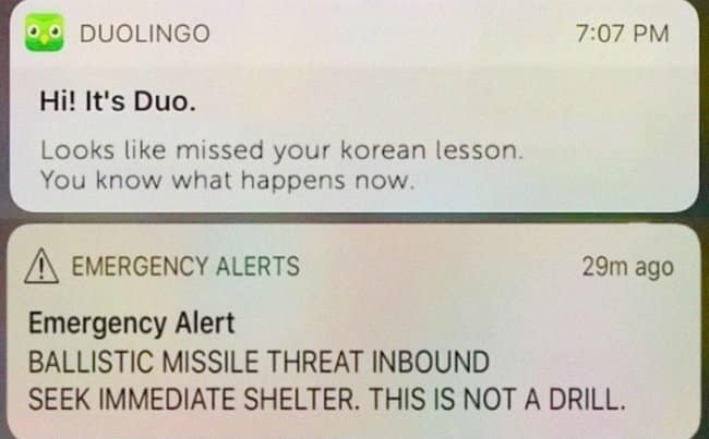 Stacked phone alerts: “Hi! It’s Duo… you missed your Korean lesson” over an Emergency Alert about an inbound ballistic missile.