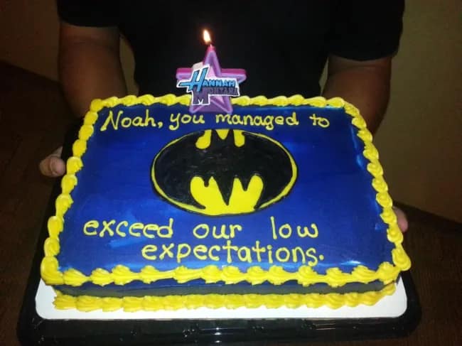 A funny cake with a backhanded compliment congratulating someone for exceeding low expectations.
