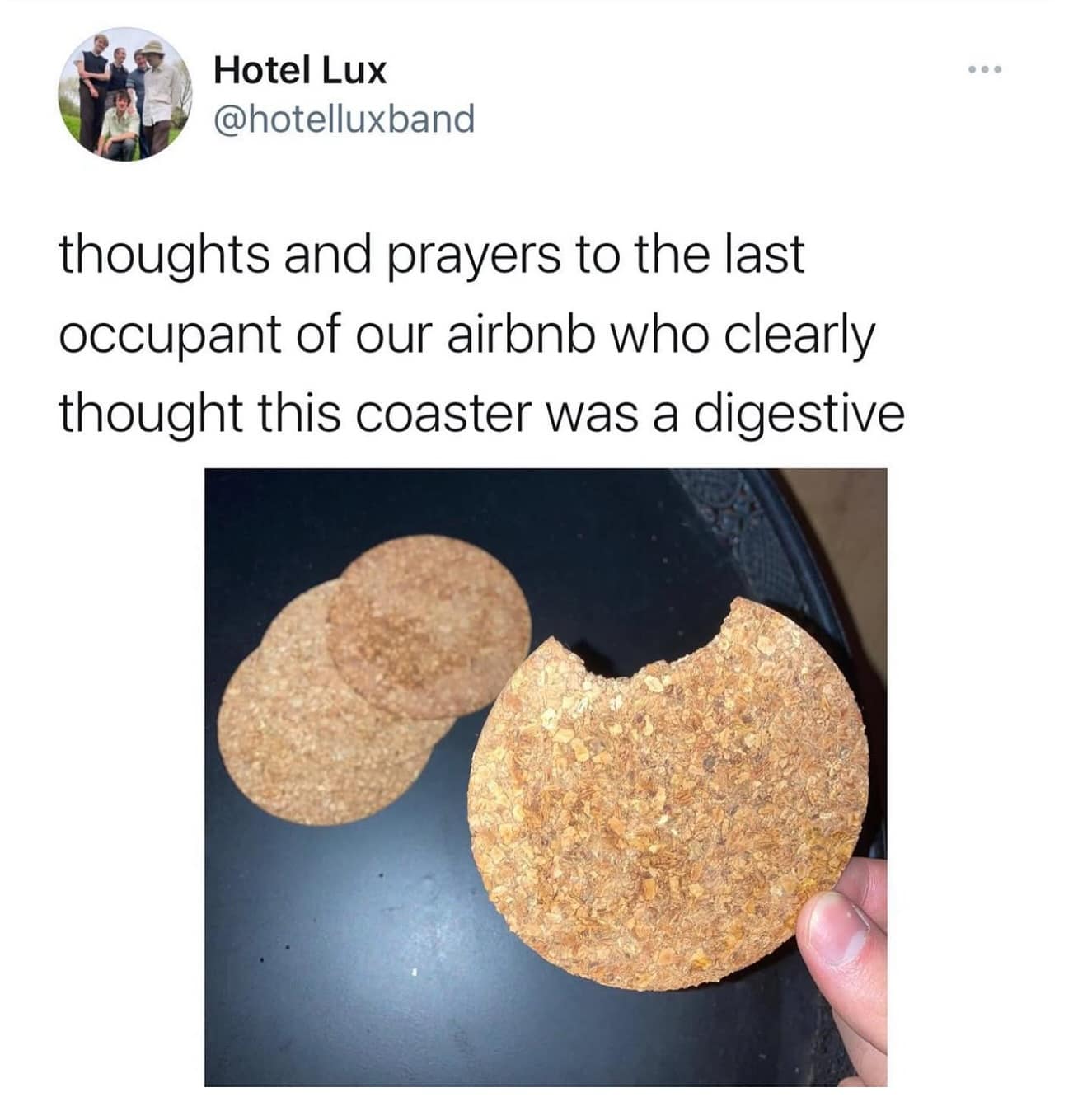 A funny photo of a cork coaster with a bite taken out, mistaken for a biscuit by an Airbnb guest.