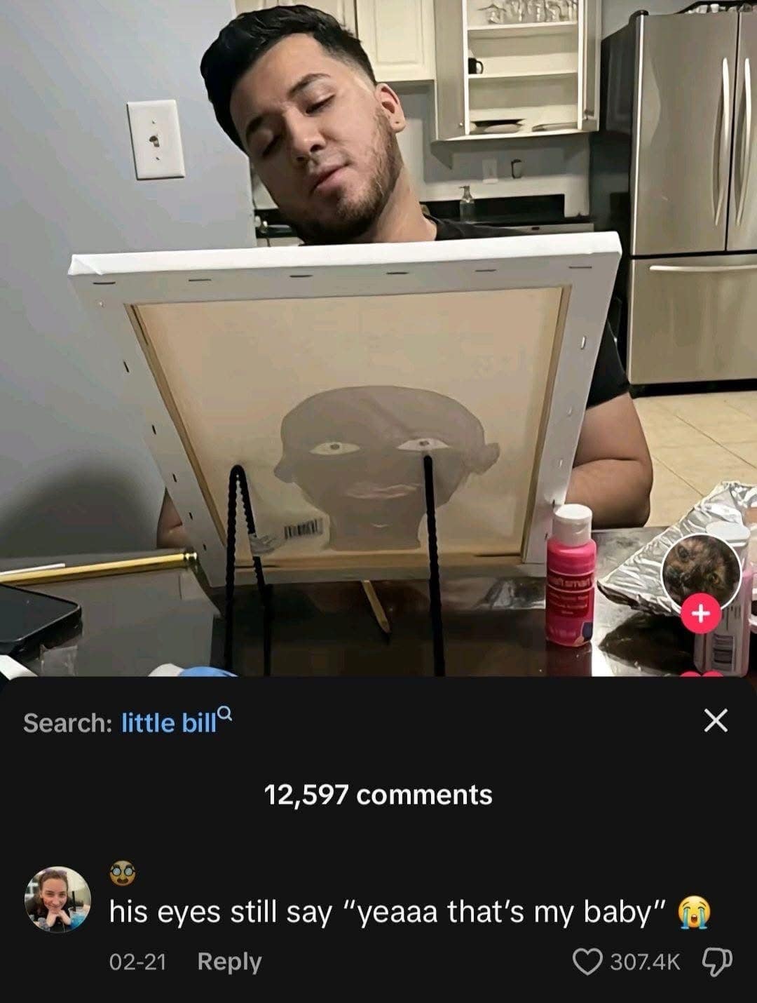 A funny pic of a man looking very proud of his terrible painting of the cartoon character Little Bill.