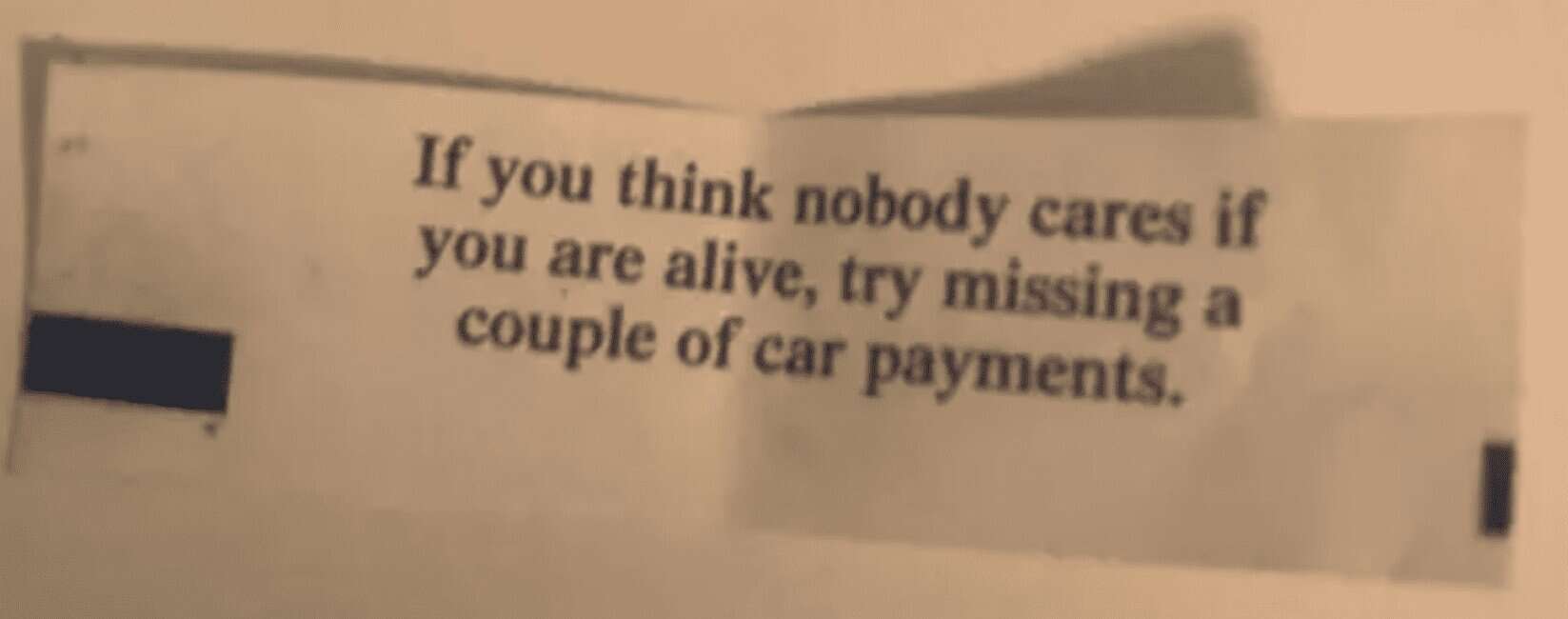 Paper slip reads, “If you think nobody cares if you are alive, try missing a couple of car payments.”
