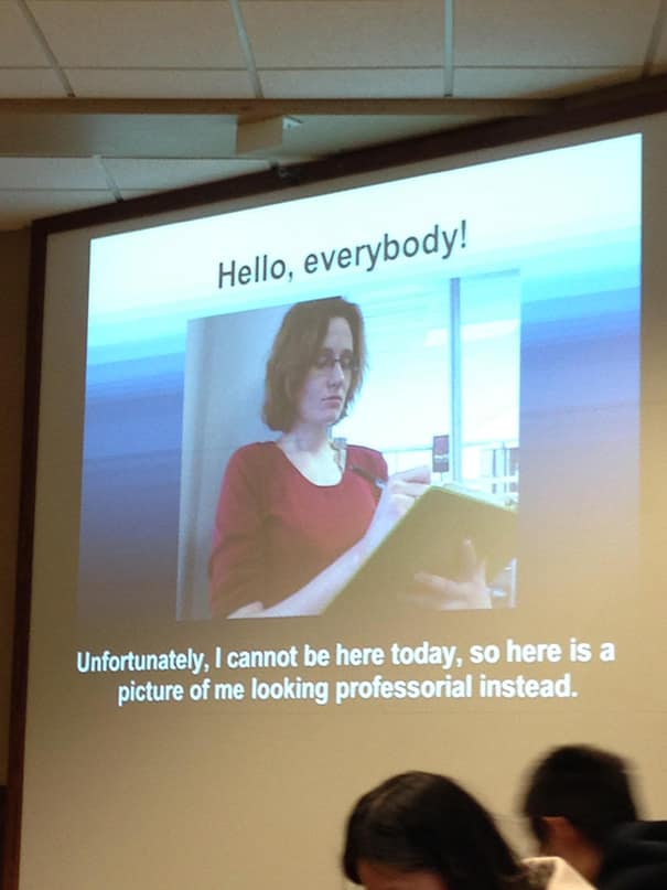 Slide in lecture hall showing a teacher’s photo with caption about being absent, playful welcome to the class.