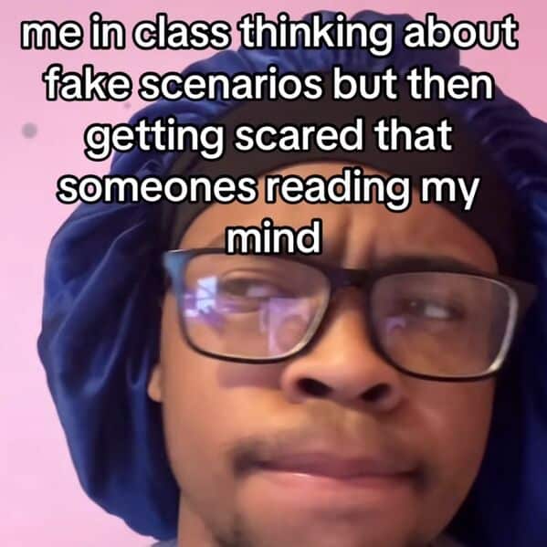 A person in a bonnet and glasses stares worriedly with the caption: “me in class thinking about fake scenarios but then getting scared that someone's reading my mind.”