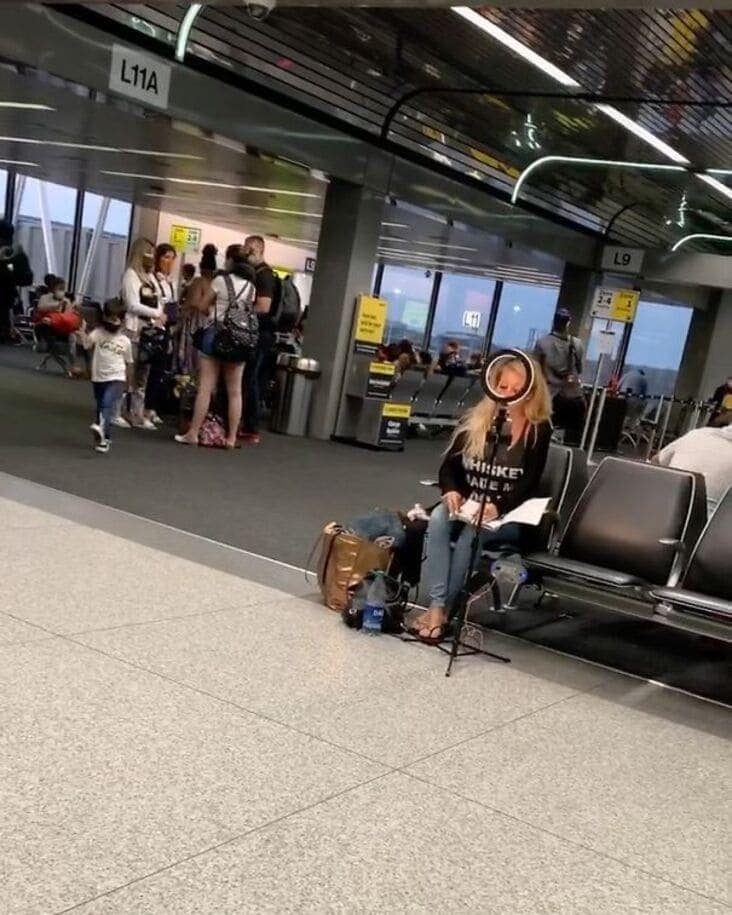 A picture of influencers getting busted for setting up a full studio in a crowded airport.