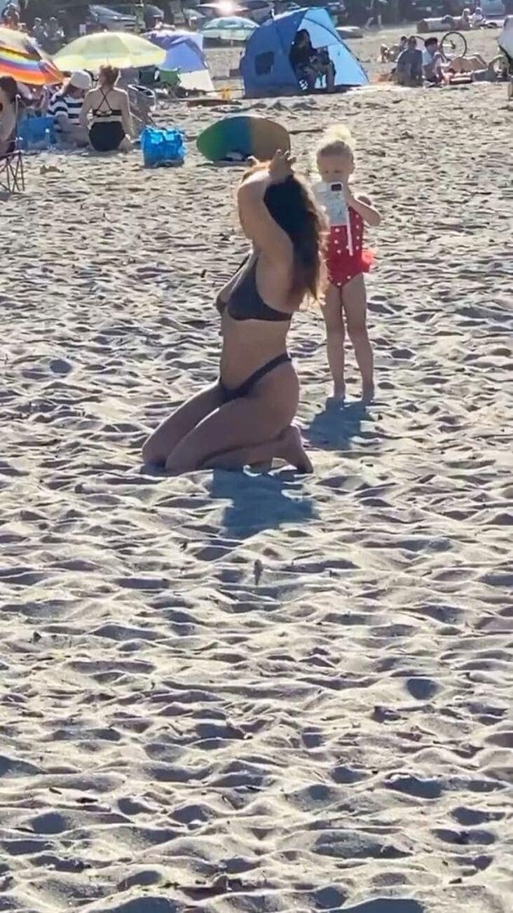 An influencer getting busted for making her young daughter take her bikini pictures on the beach.