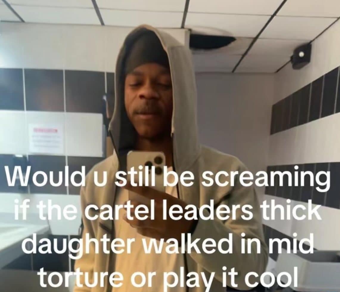 A selfie of a man in a hoodie standing in a public bathroom, with a text overlay: “Would u still be screaming if the cartel leaders thick daughter walked in mid torture or play it cool.” The absurd, dark scenario is so specific it becomes comedic.