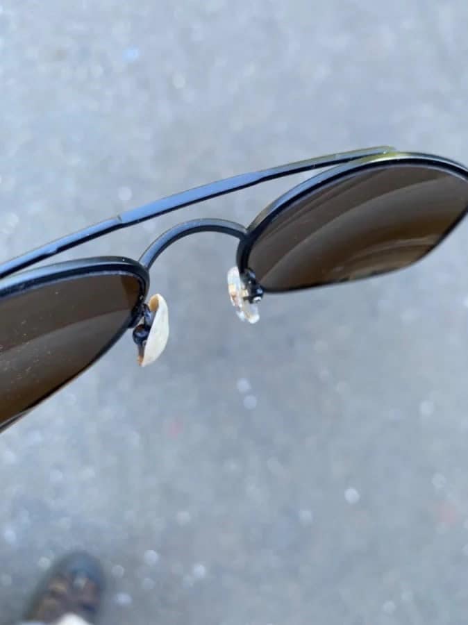 Sunglasses with one arm replaced by a tortilla chip, showing redneck ingenuity on the go.