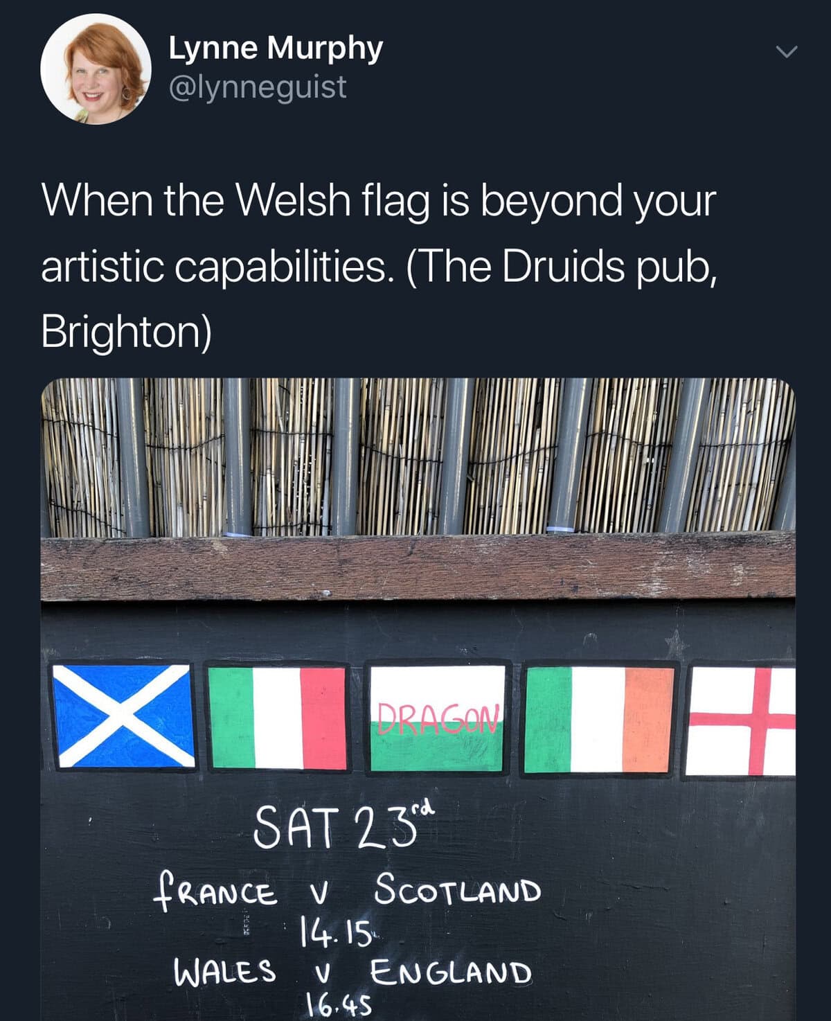 A funny "you had one job" fail of a pub sign where the Welsh flag is just the word "DRAGON".