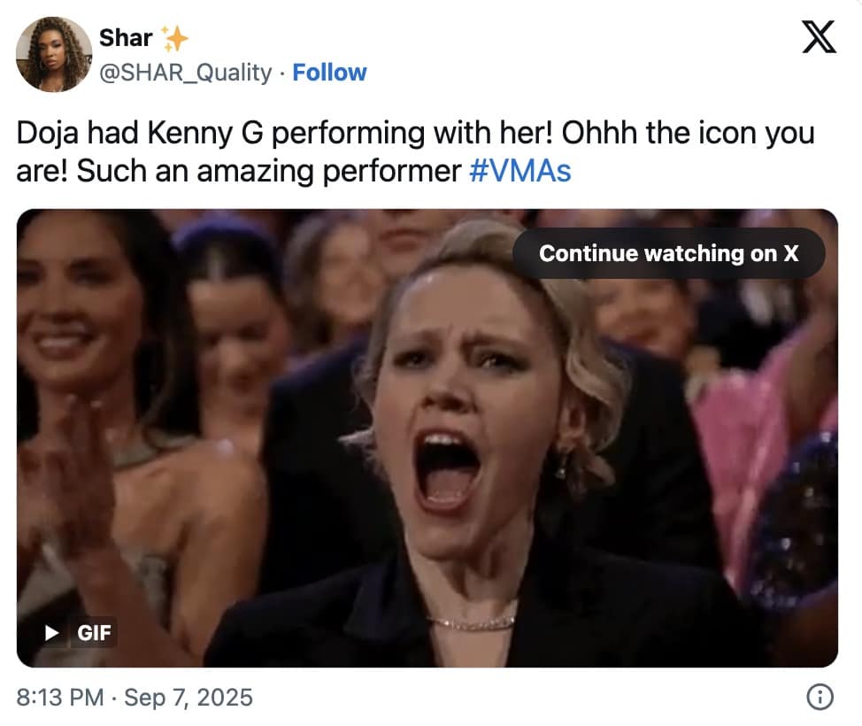 Audience member with mouth wide open cheering and clapping in delight