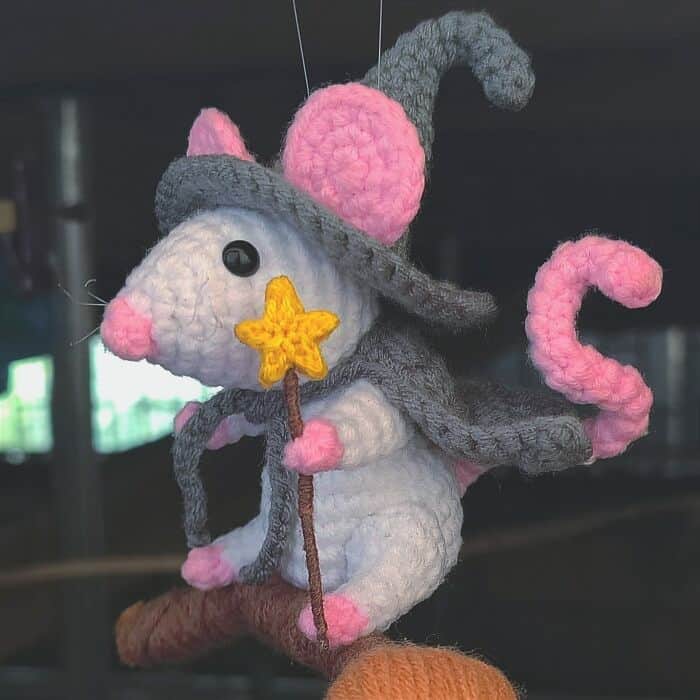 An amazing crochet piece of a tiny mouse dressed as a witch for Halloween