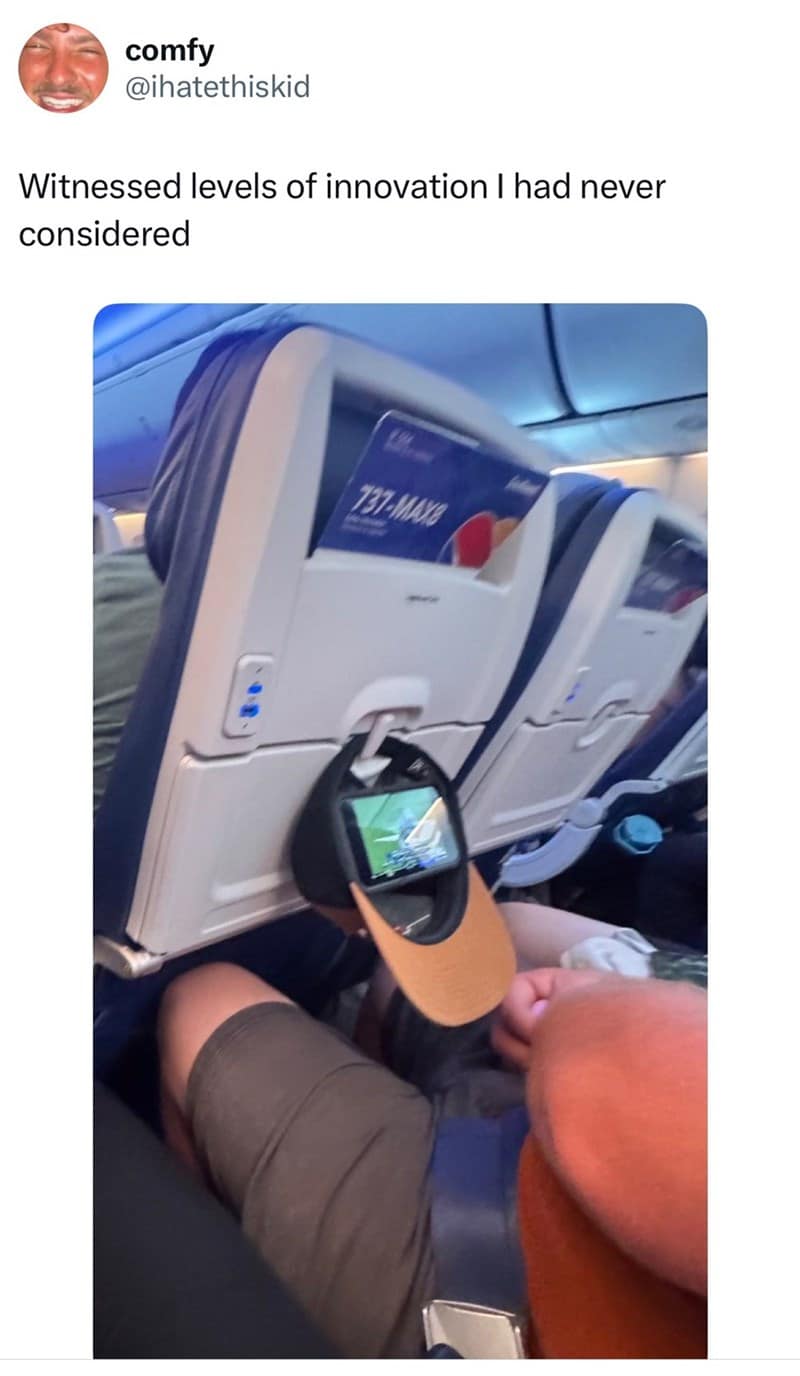 A classic meme tweet showing a person on an airplane using their hat as a phone holder.