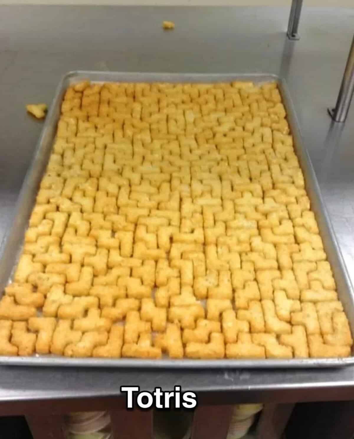 A food meme showing a baking sheet of tater tots perfectly arranged to look like the game Tetris.