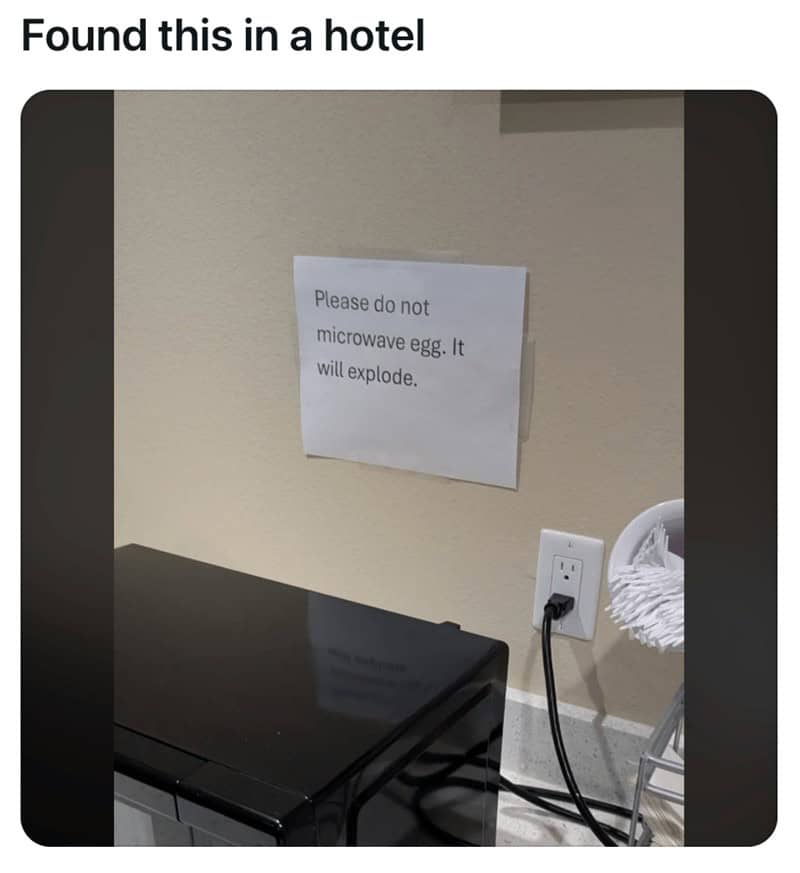 A funny sign taped above a hotel microwave that warns guests not to microwave an egg because it will explode.