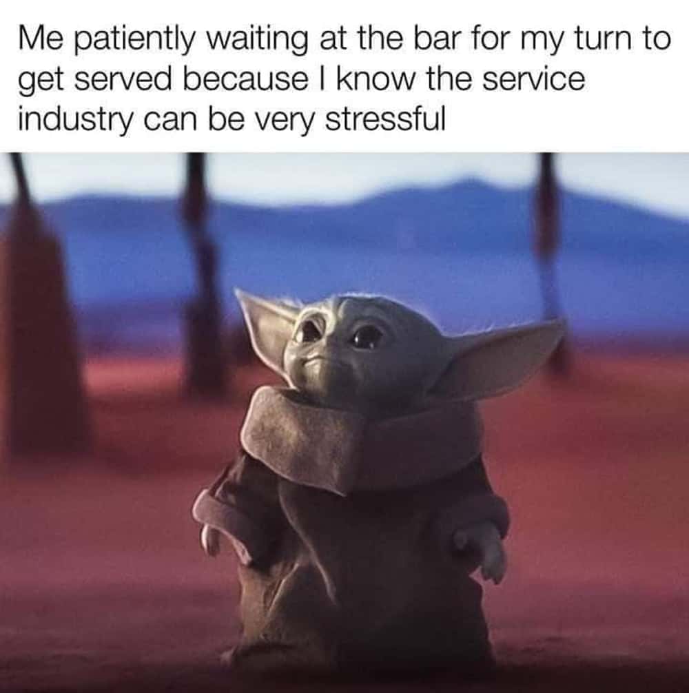 A Mandalorian and Grogu meme using a photo of a patient Grogu to represent waiting to be served at a bar.