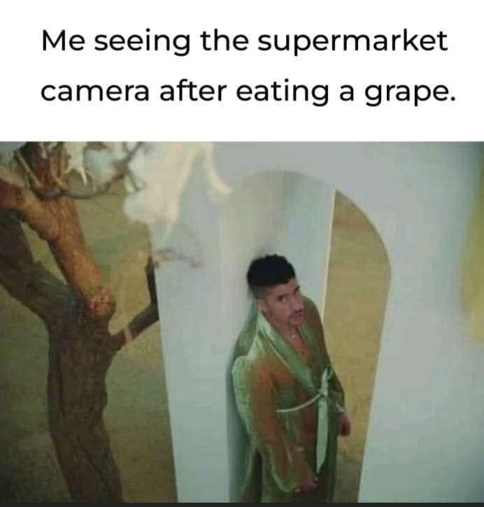 A funny meme using a picture of Bad Bunny to describe the paranoia of eating a single grape in a supermarket.