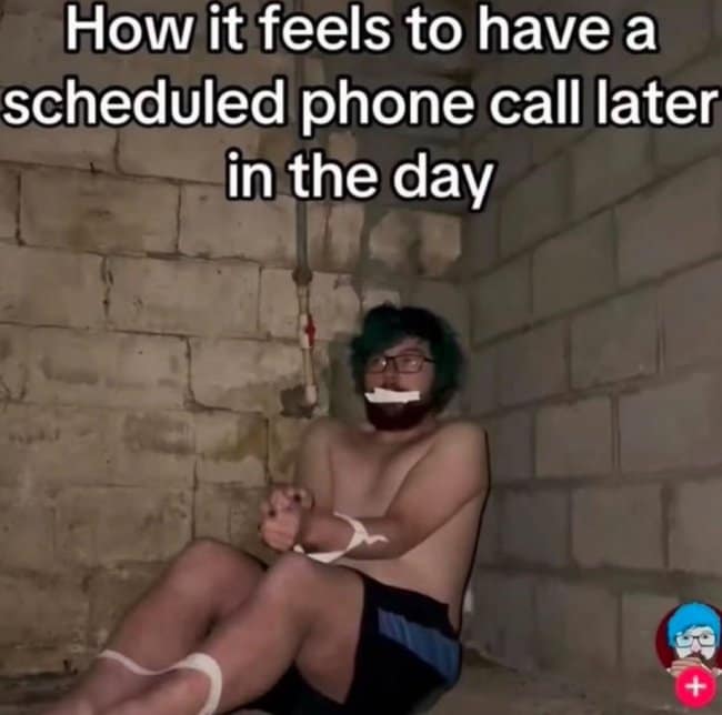 A funny and relatable meme of a person who is tied up in a basement, which is used to represent the deep, paralyzing anxiety of having a scheduled phone call.