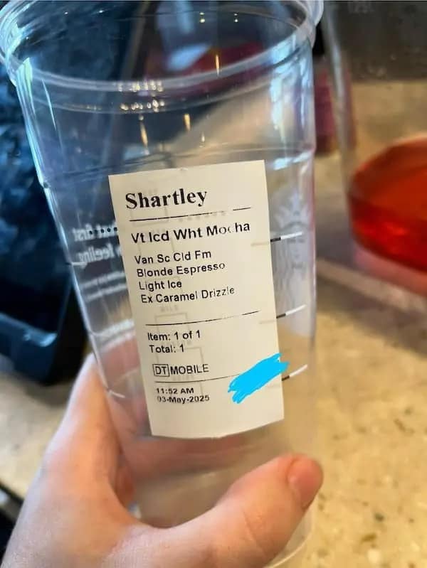 A Starbucks cup with the hilariously misspelled and bad name "Shartley" written on the label.