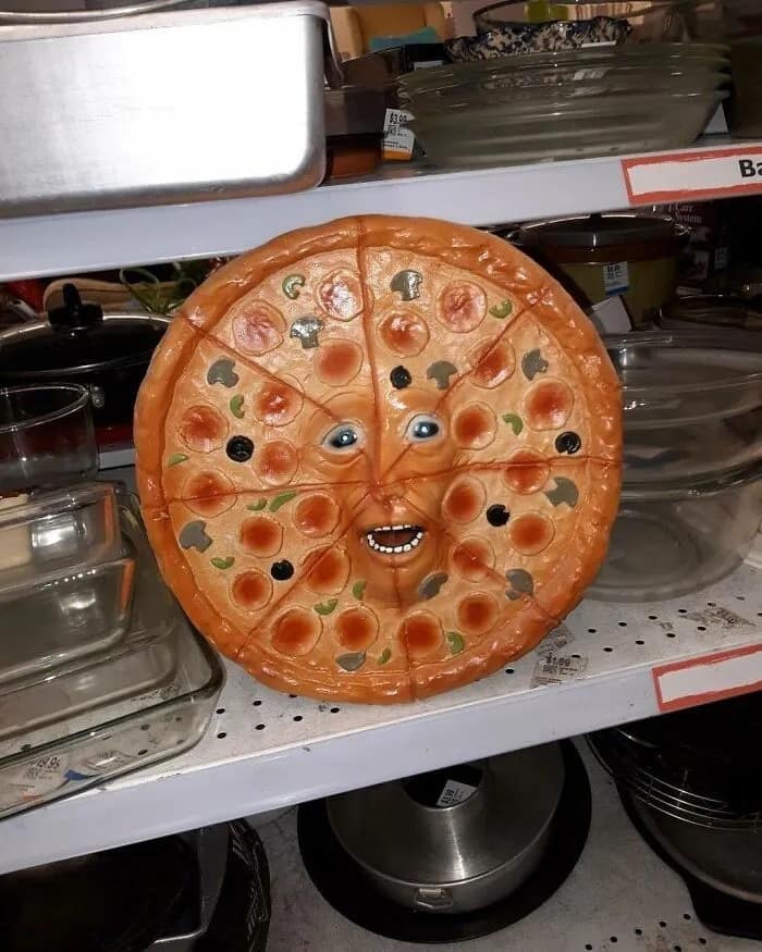 A cursed image of a creepy ceramic pizza slice platter with a horrifyingly detailed human face
