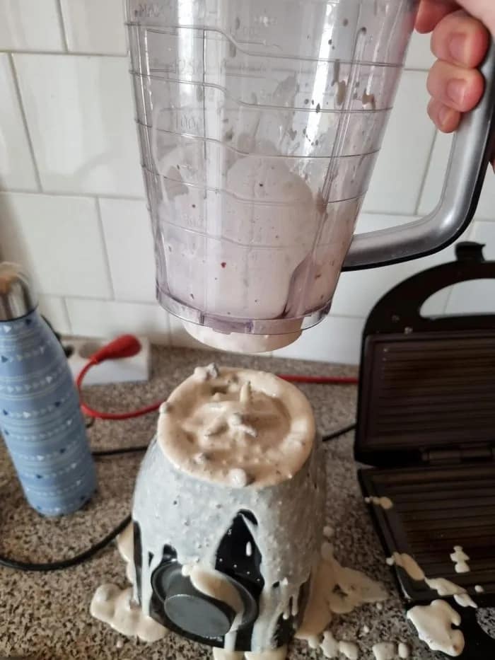 Epic fail photo showing a smoothie exploding out the bottom of a blender pitcher onto the base