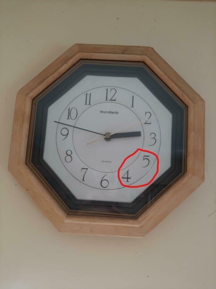 Funny fail photo of a wall clock where the numbers 4 and 5 are swapped, showing incorrect time