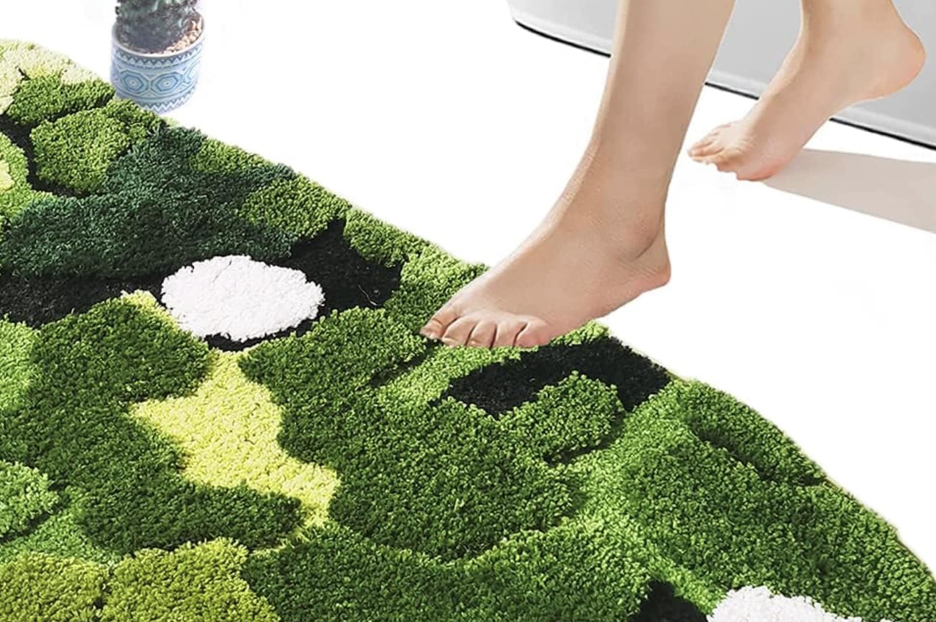 A weird funny photoshop fail showing a poorly edited foot stepping onto a bath mat advertisement.