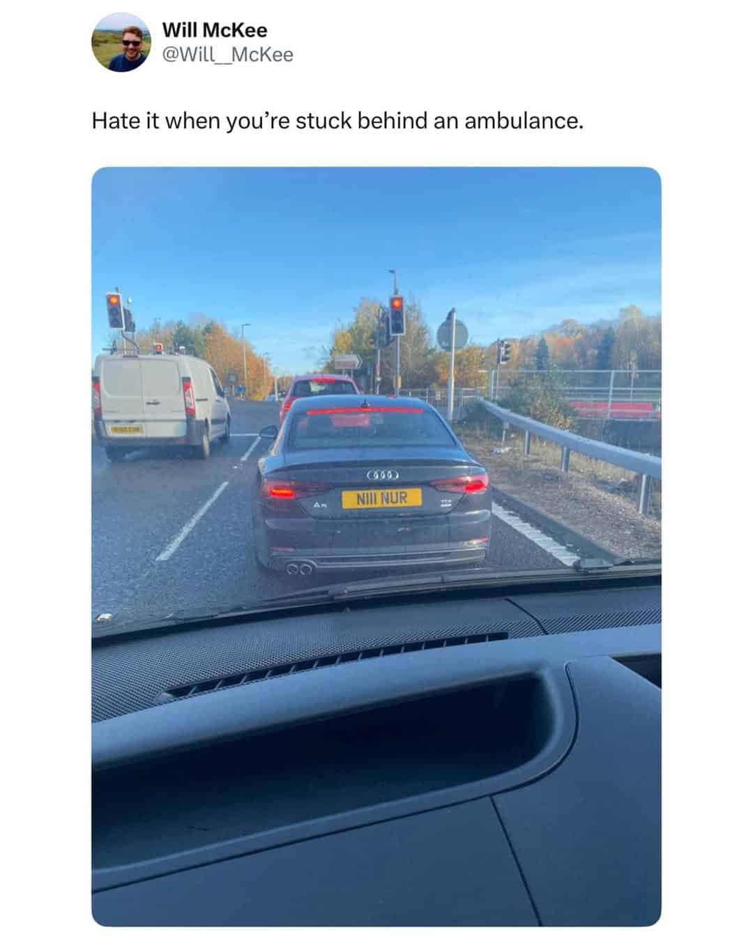 A funny British tweet and British meme pun, joking about being "stuck behind an ambulance" with a "NII NUR" license plate.