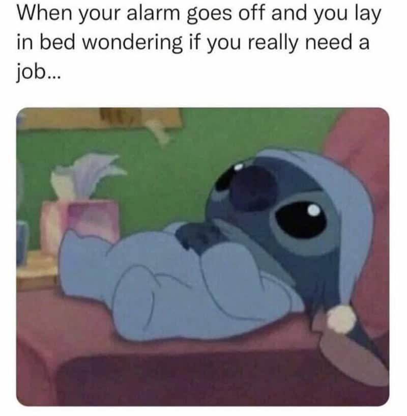 A funny anxiety meme of Stitch in bed, captioned "wondering if you really need a job" when the alarm goes off.