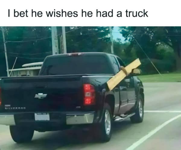 Funny, ironic photo of a pickup truck driver who put a long piece of wood through his window.