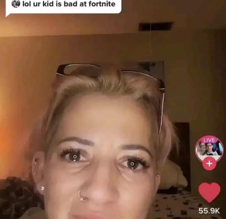 A crazy screenshot of a crying woman on TikTok, with a comment saying, "lol ur kid is bad at fortnite."