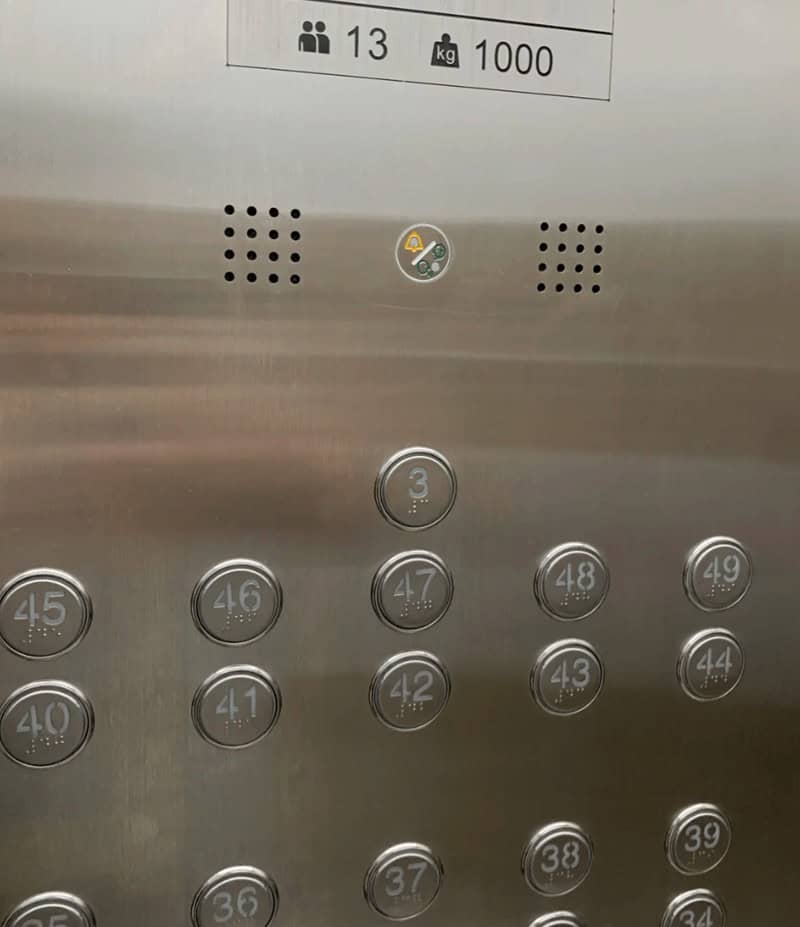 A chaotic elevator panel with buttons for floors 3, 47, 42, 38, etc., in a random order, a funny design fail.