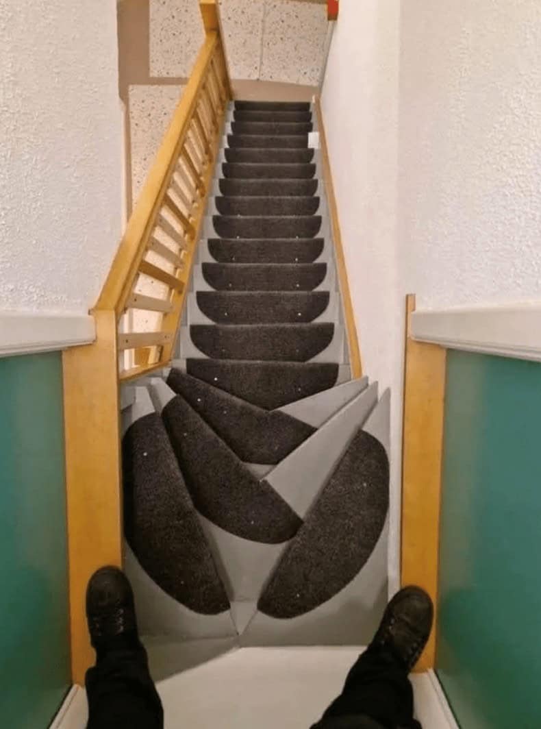 A dangerous and funny design fail showing a staircase with a chaotic carpet pattern designed to cause falls.