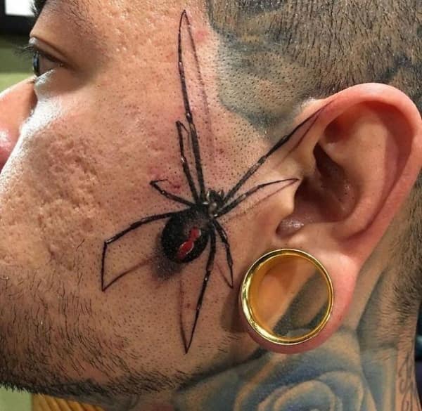 Realistic black widow spider tattoo inked on the side of a man's face.