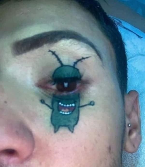 Plankton from SpongeBob SquarePants tattooed around a man's red irritated eye.