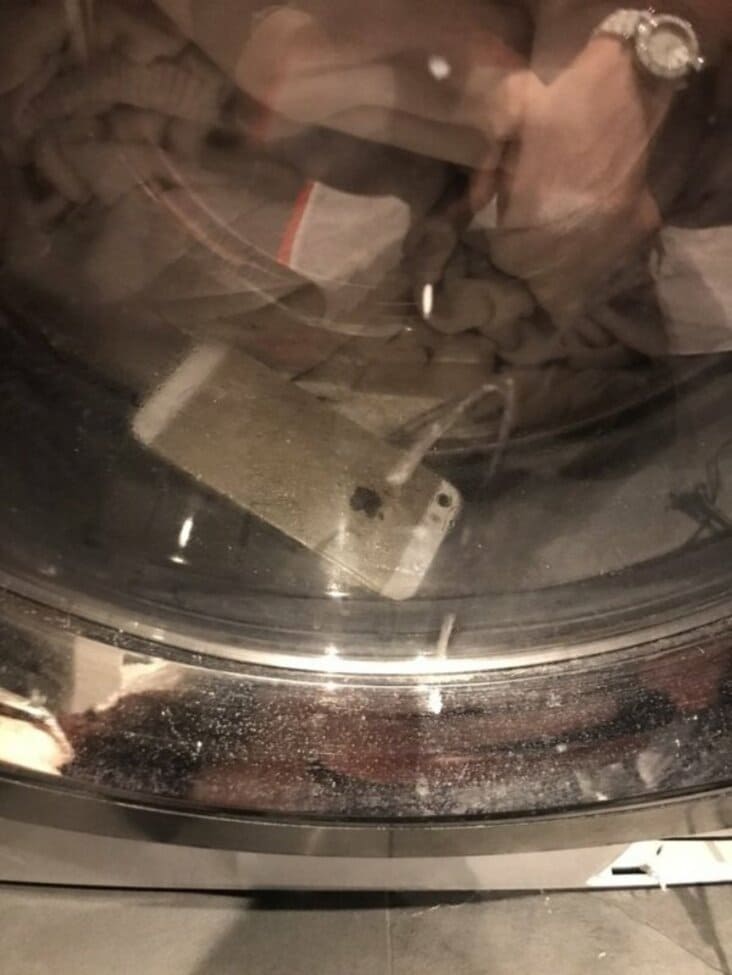 Laundry fail featuring an iPhone trapped inside a running washing machine