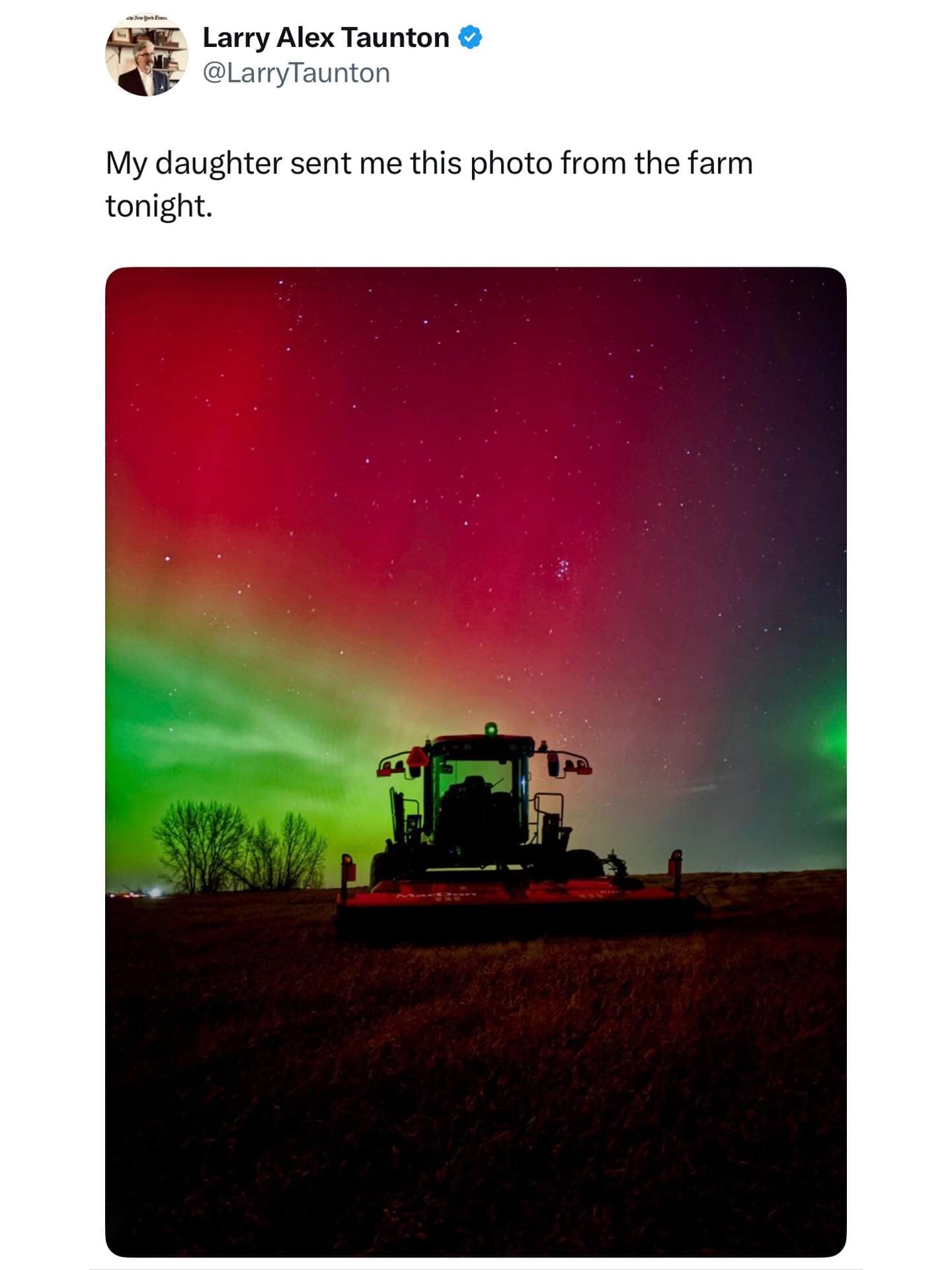 A hilarious meme of a stunning photo of the Northern Lights over a tractor, posted by a proud dad.