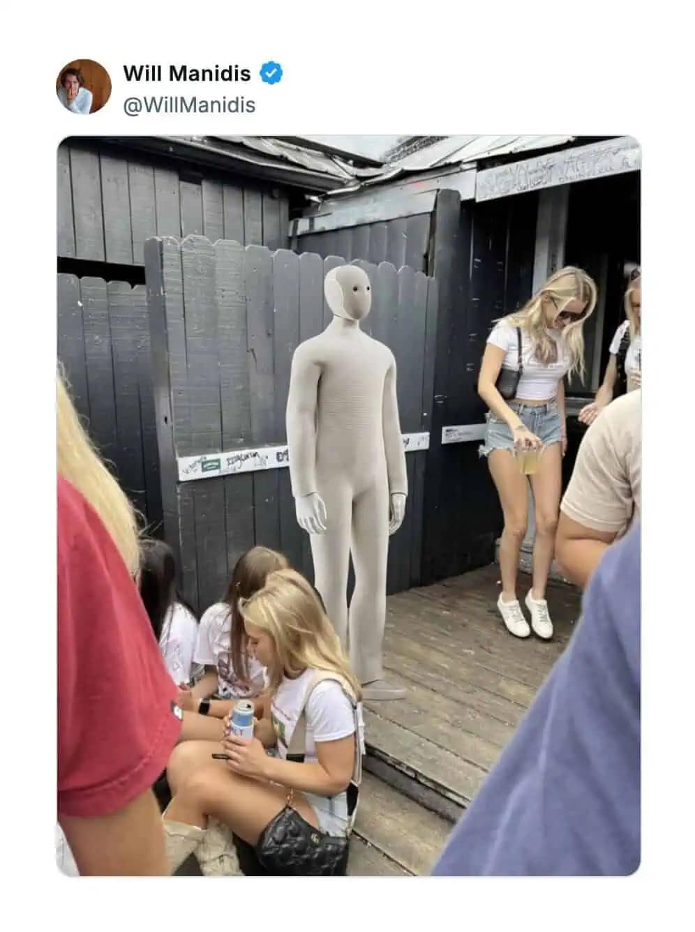 A funny neo robot meme showing the creepy humanoid robot standing awkwardly at a crowded party.