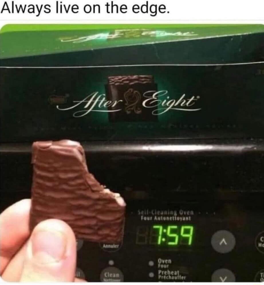 A classic meme showing a hand holding an After Eight chocolate at 7:59 on the oven clock.