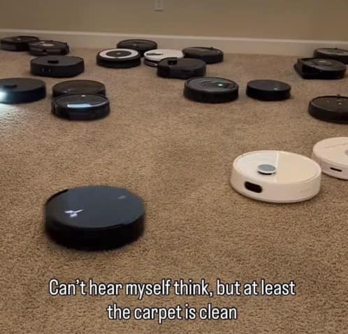 A funny meme showing a room filled with dozens of Roomba vacuums cleaning at once.
